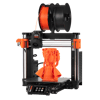 The Original Prusa MK4S, an open-frame printer with an orange print on the bed