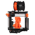 Original Prusa MK4S, drukarka z otwartą ramą z pomarańczowym wydrukiem na stole.