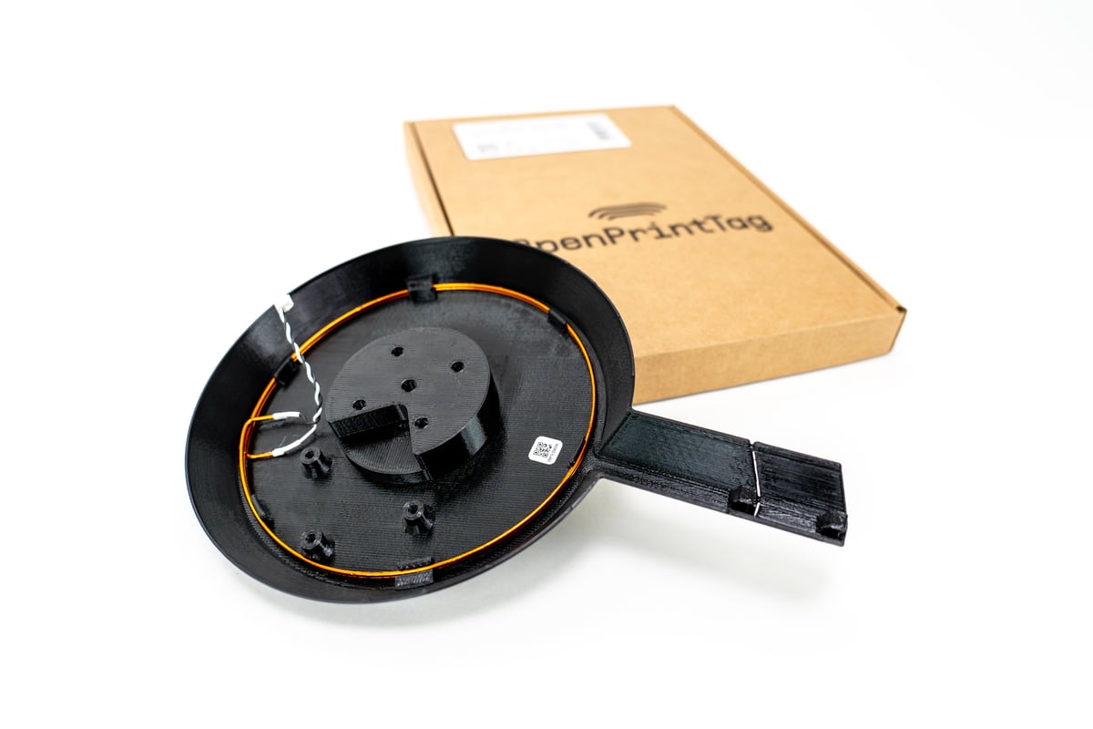 A top-down view of an OpenPrintTag NFC upgrade kit for 3D printers, displayed on a plain white background.