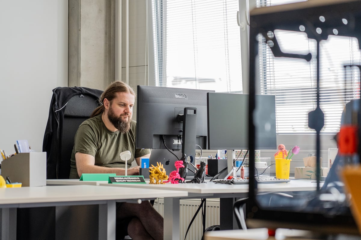 Technician servicing a 3D printer