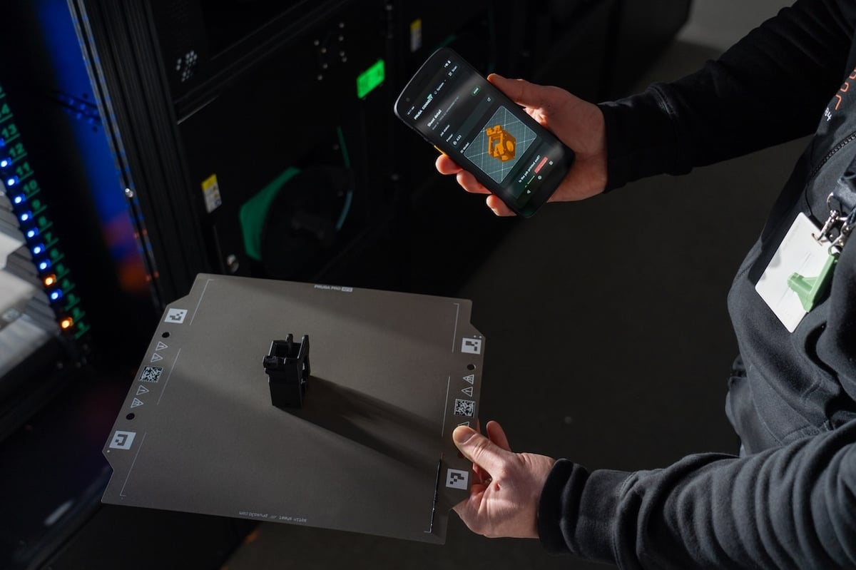 Operator removing a finished part from the print sheet