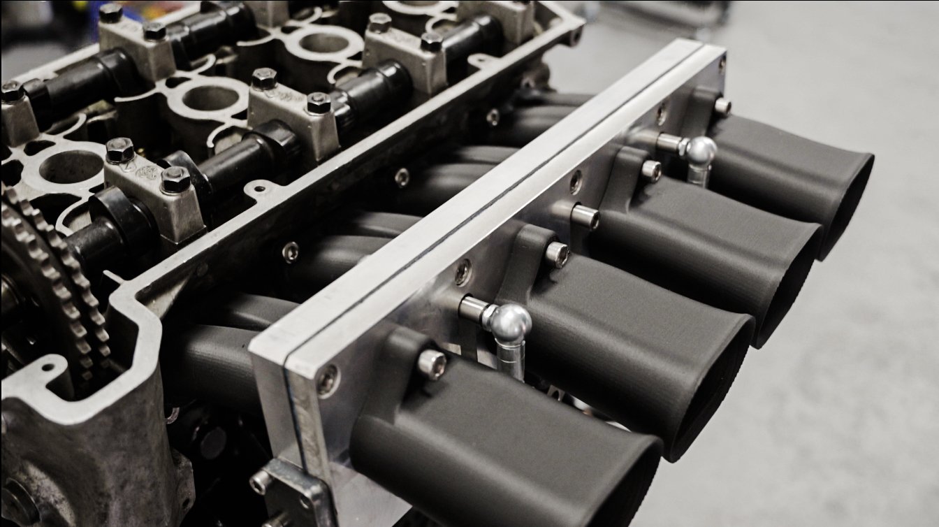 Engineering team reviewing production costs for additive manufacturing