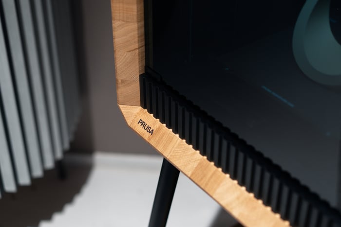 Oak corner detail of the Prusa Signature Oak showing the natural wood grain and PRUSA brand mark